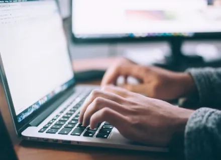 A student taking an online course on a laptop